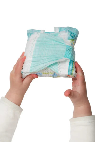 Baby's hands hold dirty diapers — Stock Photo, Image