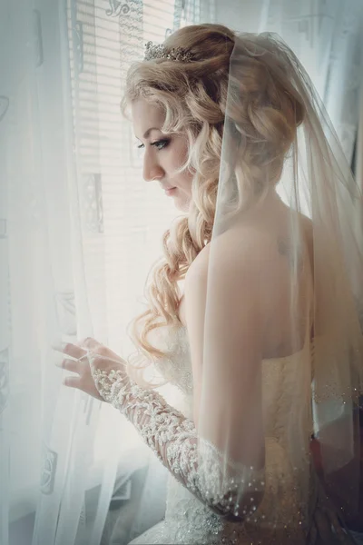 Happy bride is looking in window — Stock Photo, Image