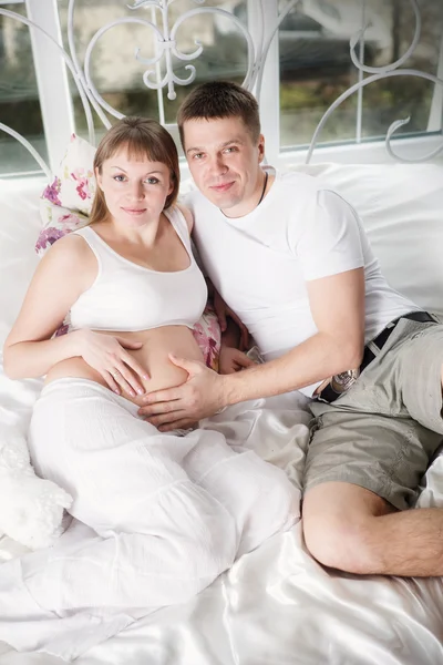 Mujer embarazada con su marido en casa —  Fotos de Stock