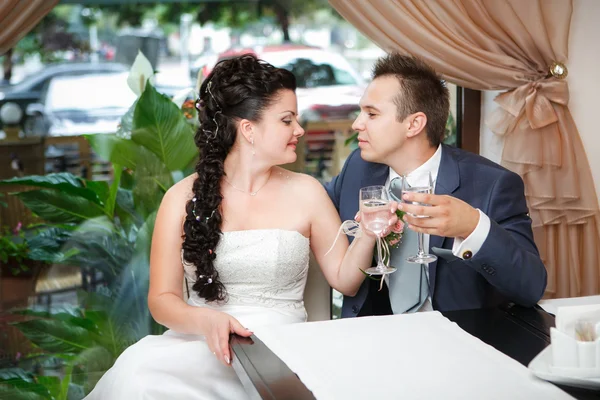 Closeup portrait of bride and groom drinking champagne at luxury restaurant — Stock Photo, Image