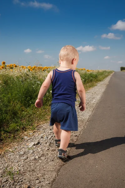 Niño corriendo en un camino de asfalto — Foto de Stock