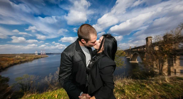 Lovely young couple kissing outdoors in autumn — Stock Photo, Image