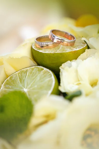 Obrączki ślubne leżą na plasterek cytryny z bliska — Zdjęcie stockowe
