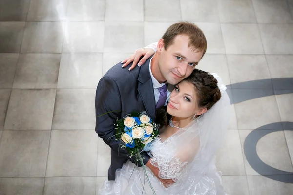 Groom and the bride with a wedding bouquet from roses in a hand Royalty Free Stock Images