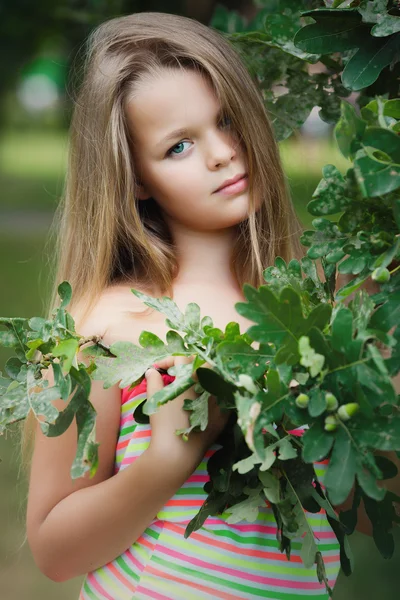 Menina em folhas verdes . — Fotografia de Stock