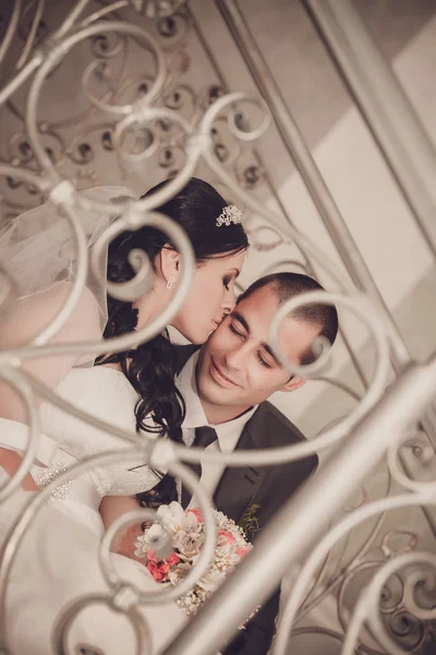 Close up portrait of happy bride and groom on front staircase — Stock Photo, Image