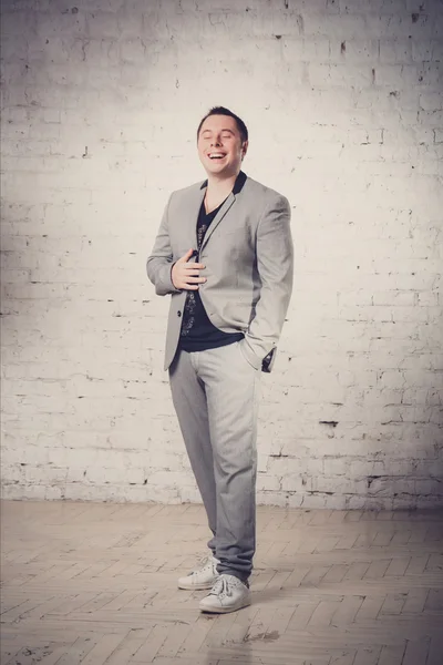 Portrait of fashion young man in gray suit  at studio — ストック写真