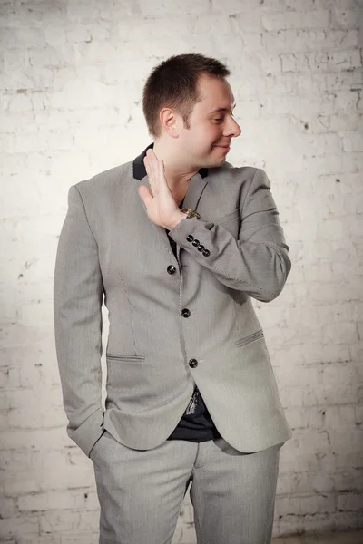 Portrait of fashion young man in gray suit  at studio — ストック写真