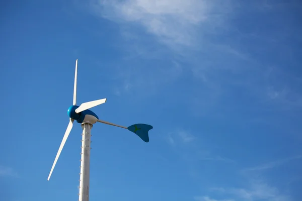 Green renewable energy concept - wind generator turbines on blue — Stock Photo, Image