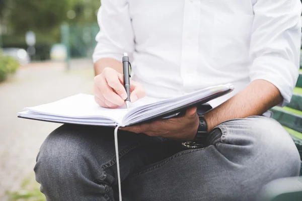 Homem escrevendo em sua agenda — Fotografia de Stock