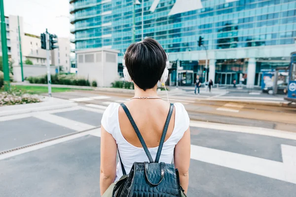 Frau mit Rucksack hört Musik — Stockfoto