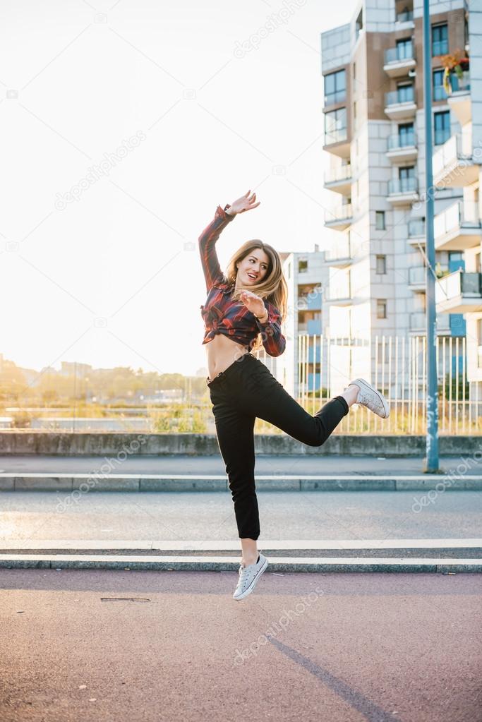 woman jumping looking over smiling