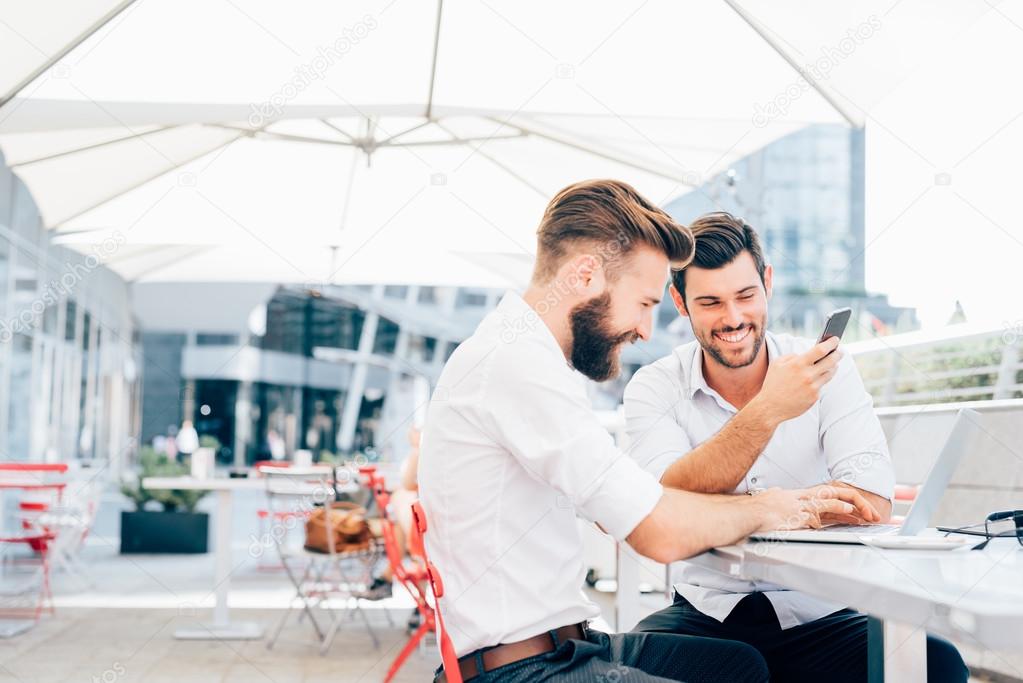 Two young businessmen working outdoor