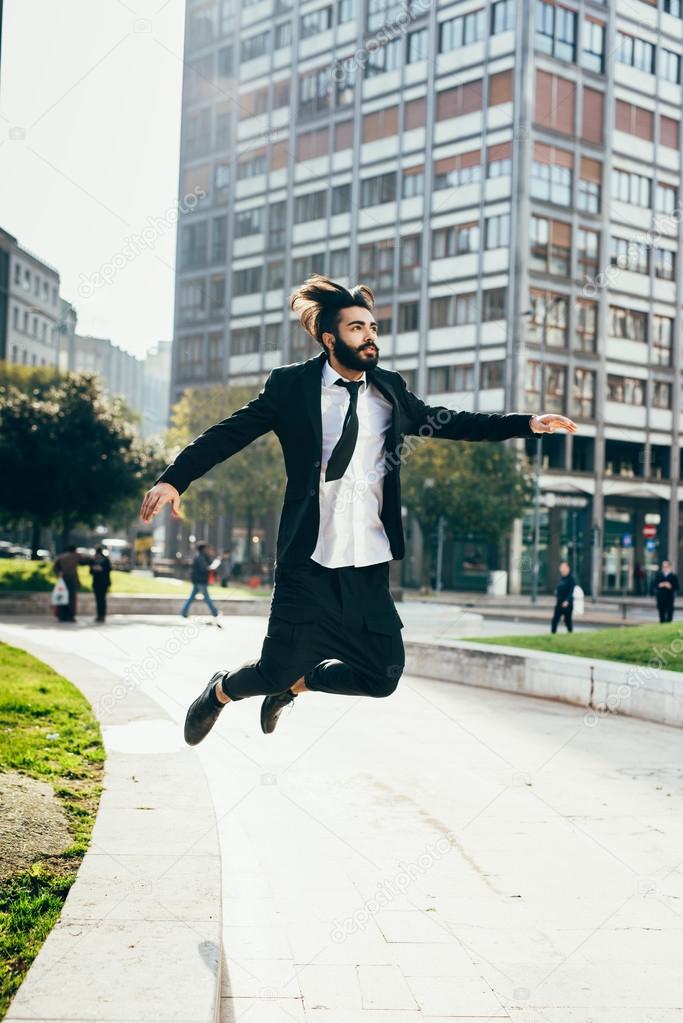 contemporary businessman jumping in city