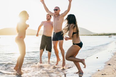 young multiethnic friends jumping