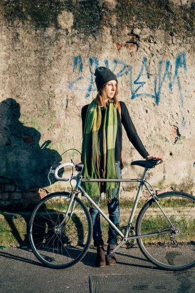 Mujer rubia sosteniendo una bicicleta — Foto de Stock