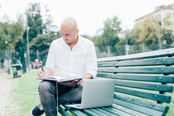 Man sitting on a bench in park — Stock Photo, Image