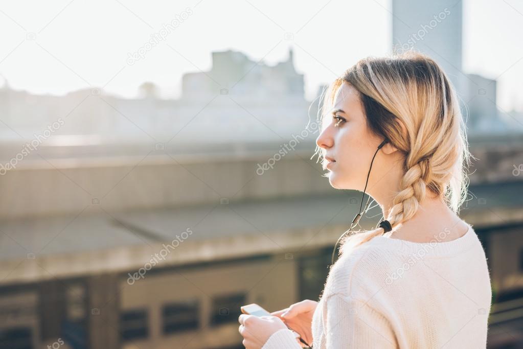 woman listening music with earphones