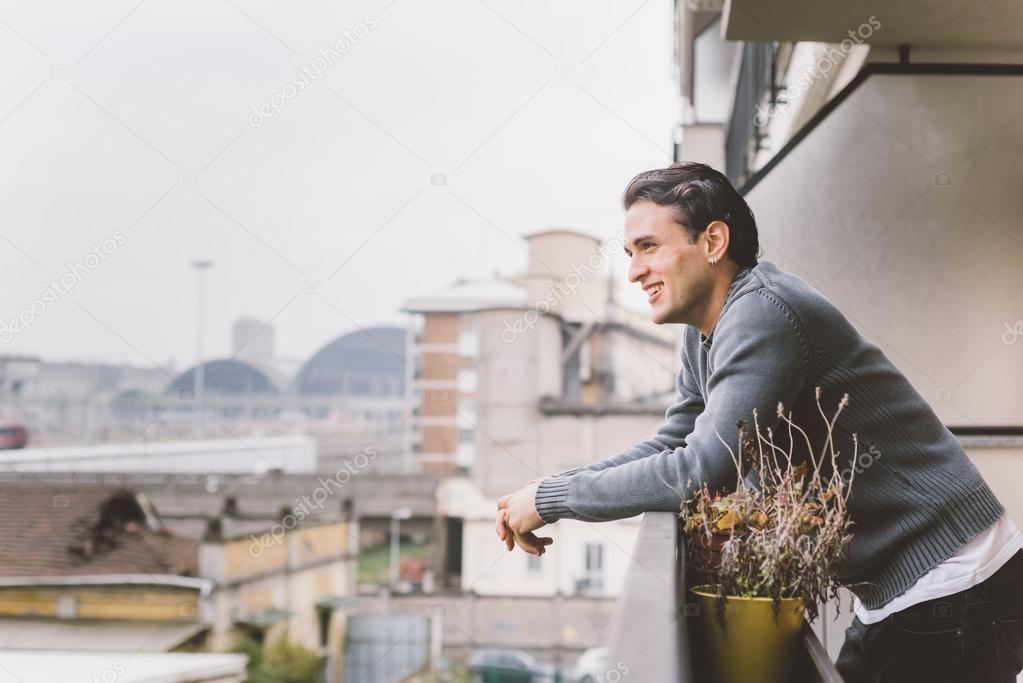 man standing on a balcony 