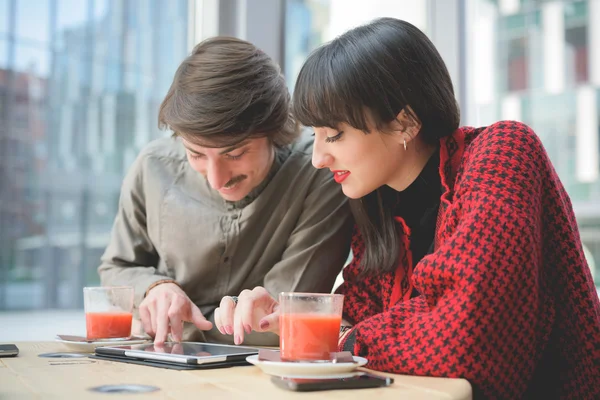 Business colleagues seated on bar using tablet — Stock Photo, Image