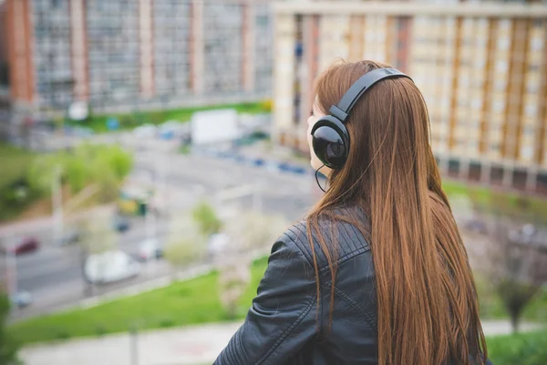 Chica morena escuchando música con auriculares — Foto de Stock