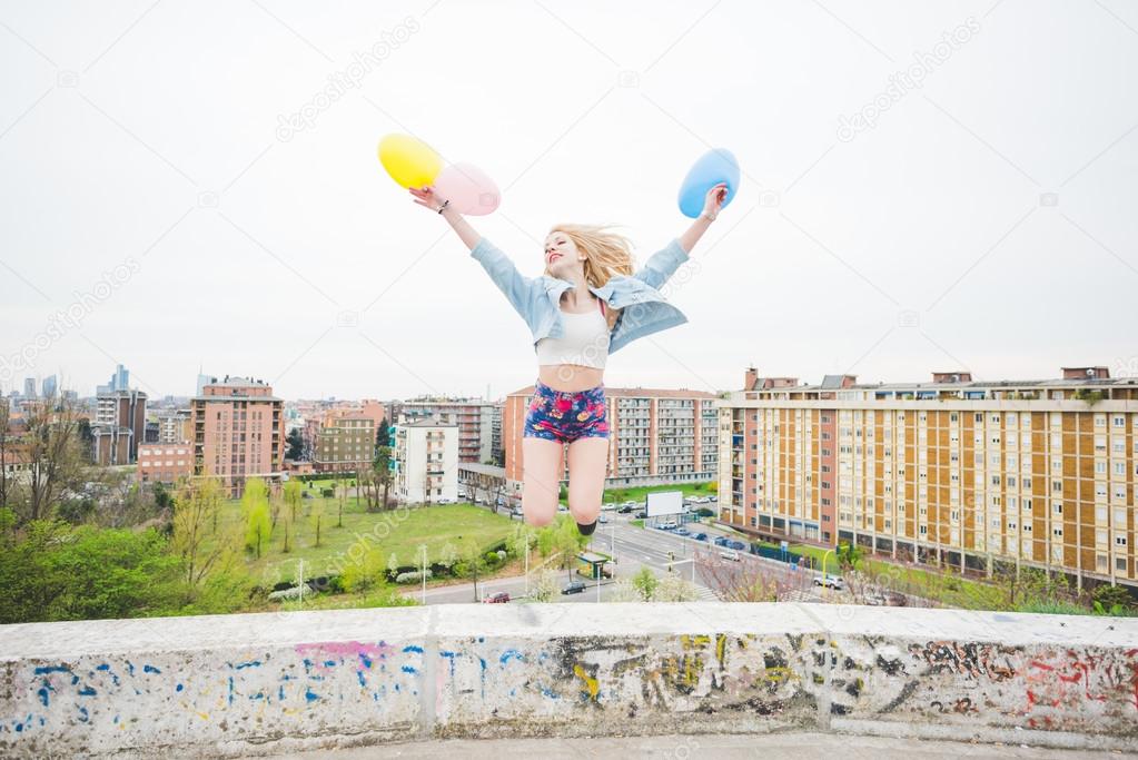  girl playing with colorful balloons