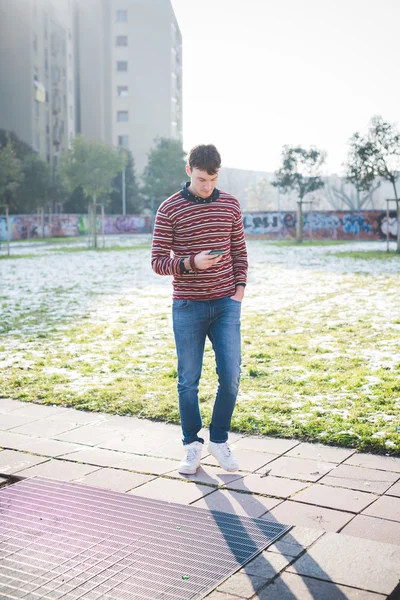 Young handsome man using smartphone — Stock Photo, Image