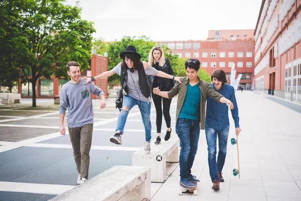 Multiethnic friends walking down the street — Stock Photo, Image