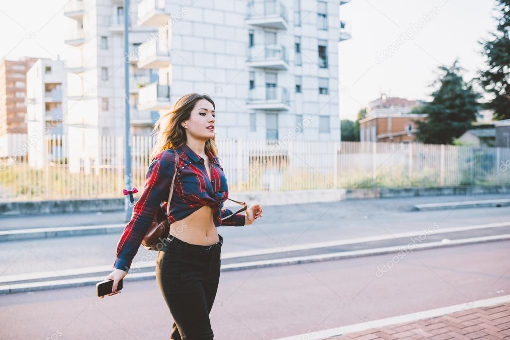 woman walking in street of city