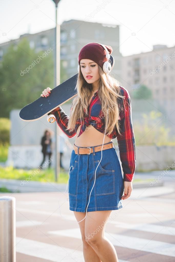 woman skater holding skateboard