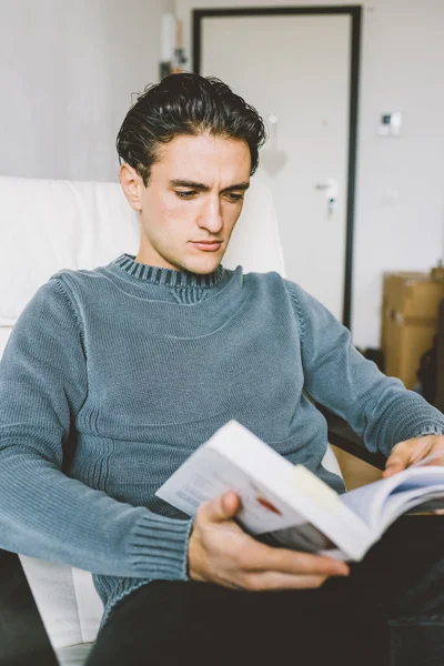 Man sitting on armchair in house — Stock Photo, Image