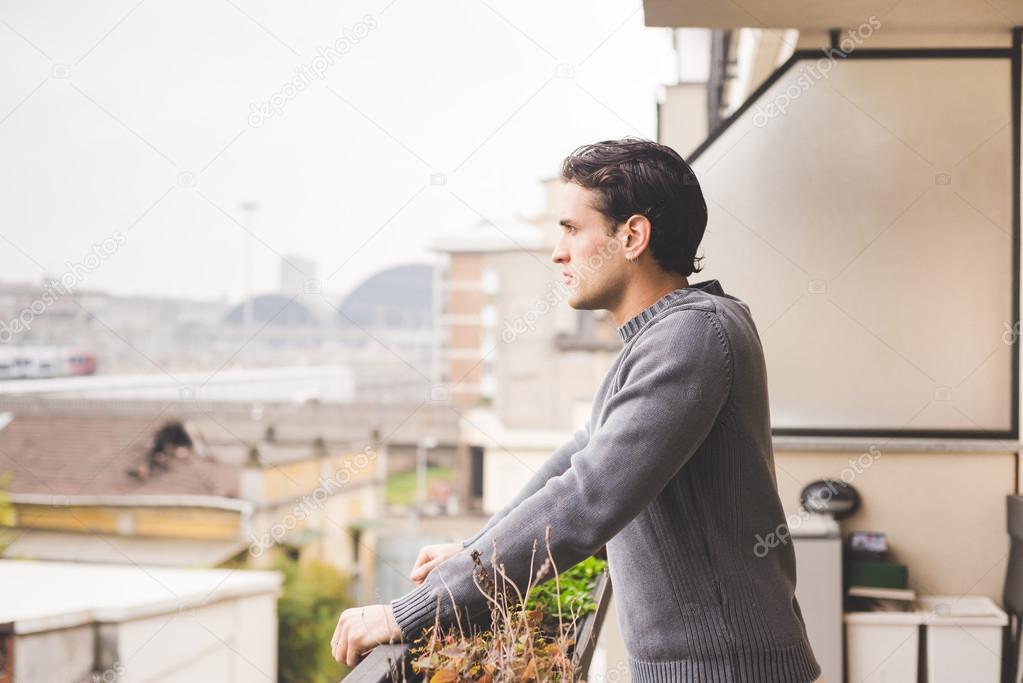 man standing on a balcony outdoor