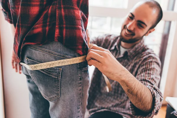 designer working on garment on a model