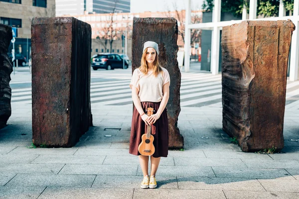 Mulher segurando um ukulele ao ar livre — Fotografia de Stock