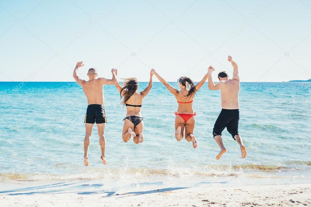 friends jumping into water