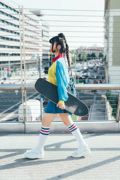 Asiatin läuft mit Skateboard — Stockfoto