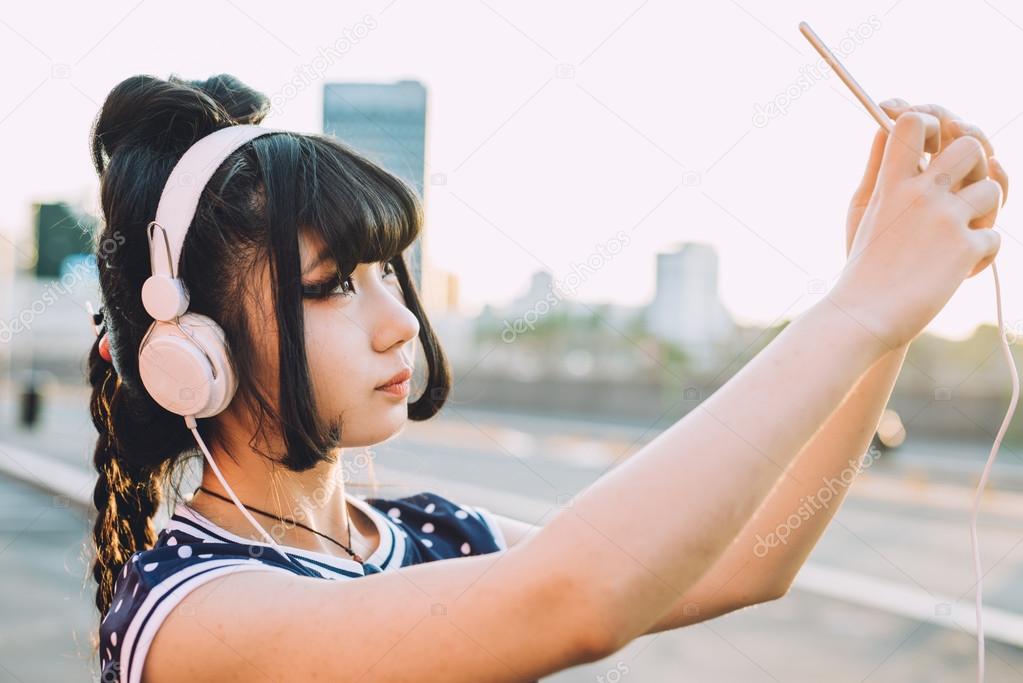 asian millennial woman listening music