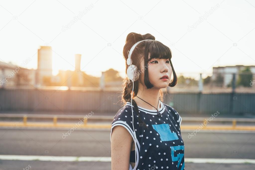 asian millennial woman listening music 