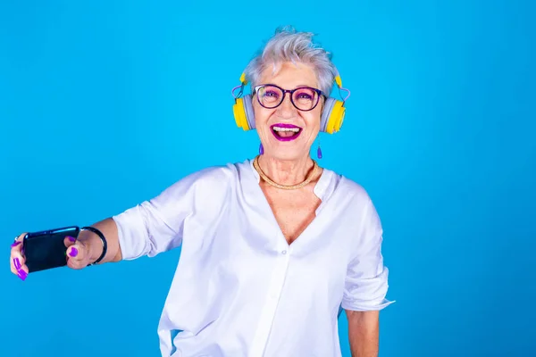 Old Senior Woman Enthusiastic Dancing Listening Music Holding Smartphone Isolated — Stock Photo, Image