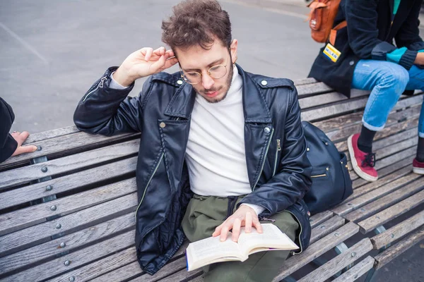 年轻的高加索人坐在长椅上 在户外看书 放松心情 准备考试 大学生专攻小说 — 图库照片