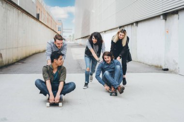 Bir grup arkadaş haftasonu kaykay yarışı yaparak ve can sıkıntısıyla savaşarak eğleniyor.