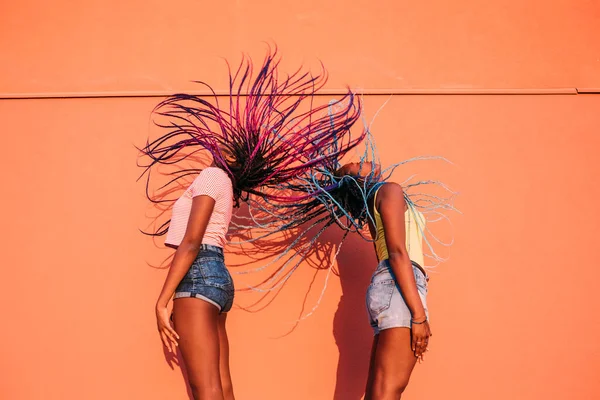 Two Women Sisters Dancing Moving Hair Outdoor Orange Background Showing — Stock Photo, Image