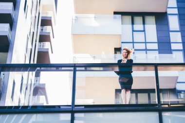 Açık hava rüzgarı kullanan genç sarışın iş kadını.