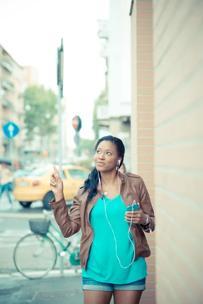 African woman listening music earphones — Stock Photo, Image