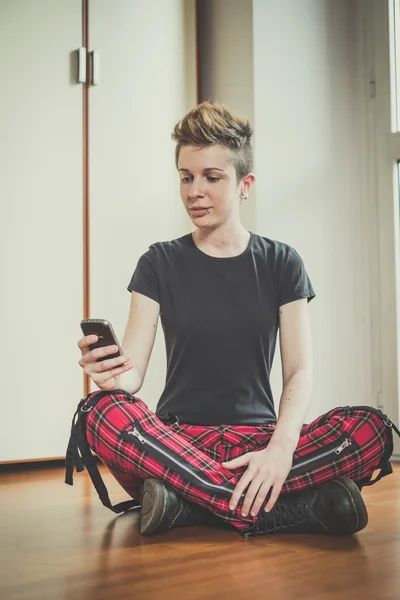 Young lesbian stylish hair style woman using smart phone — Stock Photo, Image