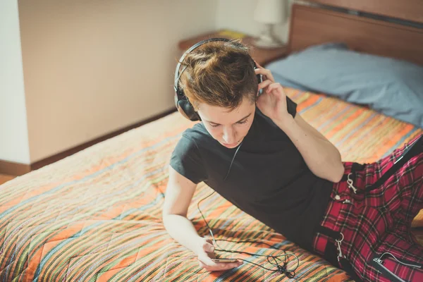 Young lesbian stylish hair style woman listening to music — Stock Photo, Image