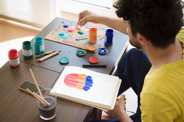 Handsome hipster modern man painting — Stock Photo, Image