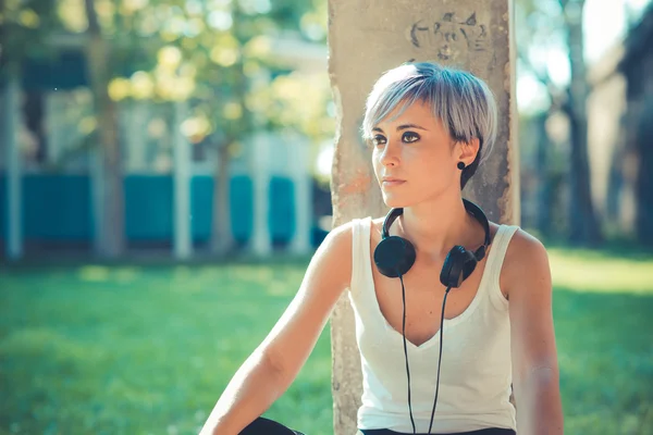 Jovem bonita cabelo azul curto hipster mulher com fones de ouvido mu — Fotografia de Stock