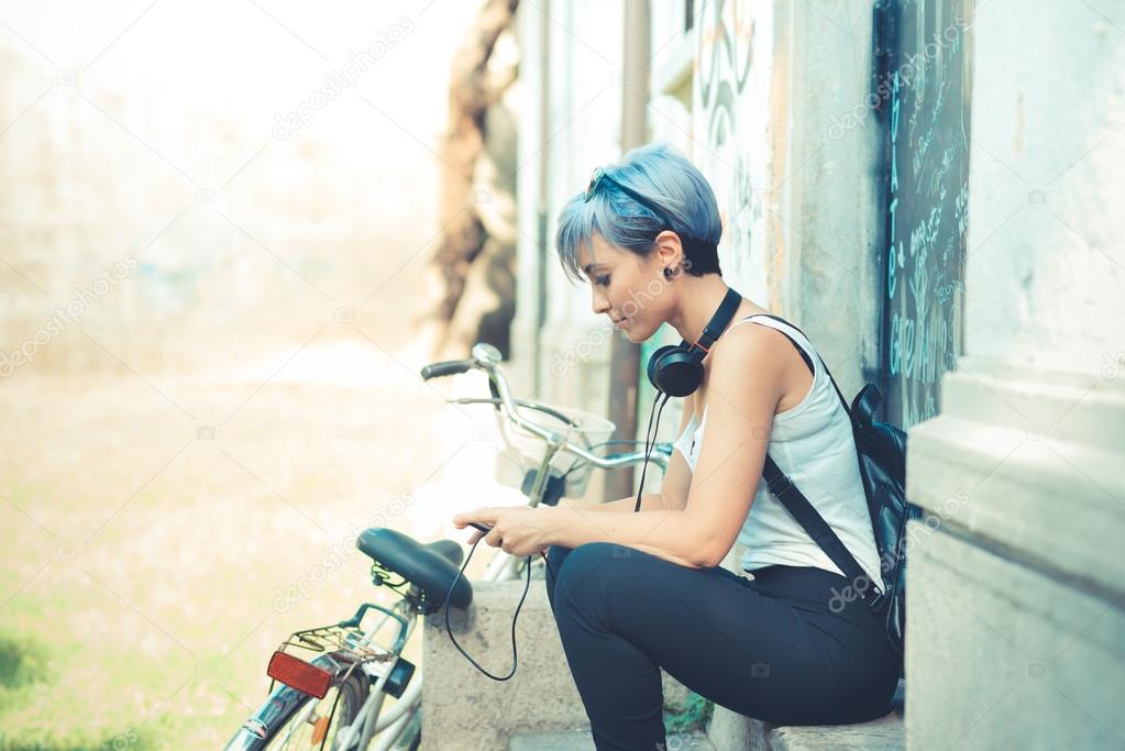 young beautiful short blue hair hipster woman with headphones an