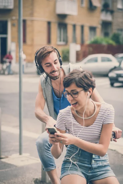 Couple of friends young  man and woman riding bike — Stock Photo, Image